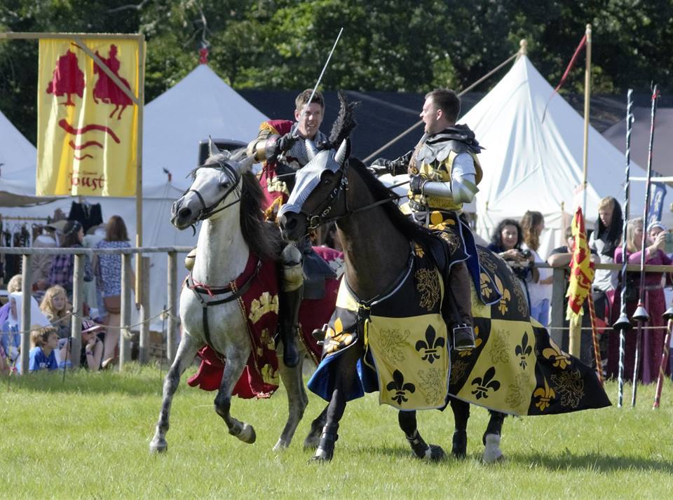 A picture of re-enactors demonstrating jousting on horseback